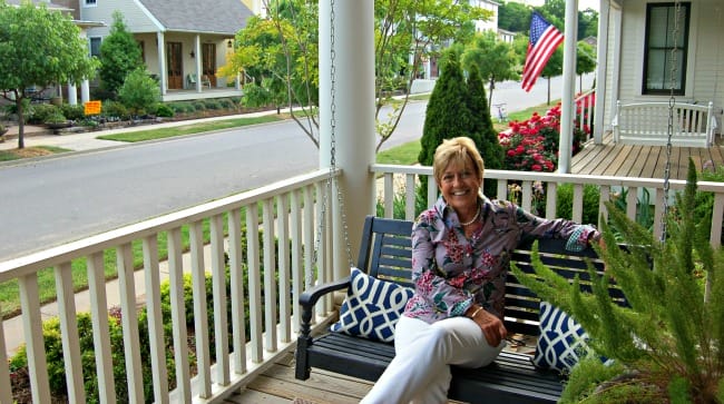 Sarah Frost on porch swing Hendrix Village