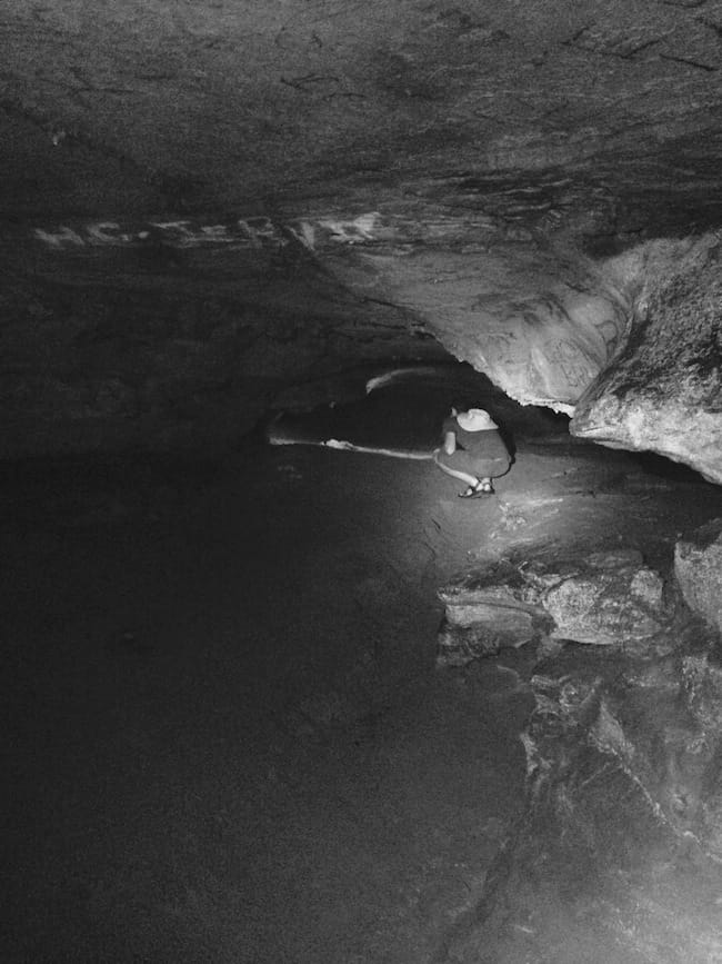 Noah Examines a Drop-off in the Old Saltpeter Cave