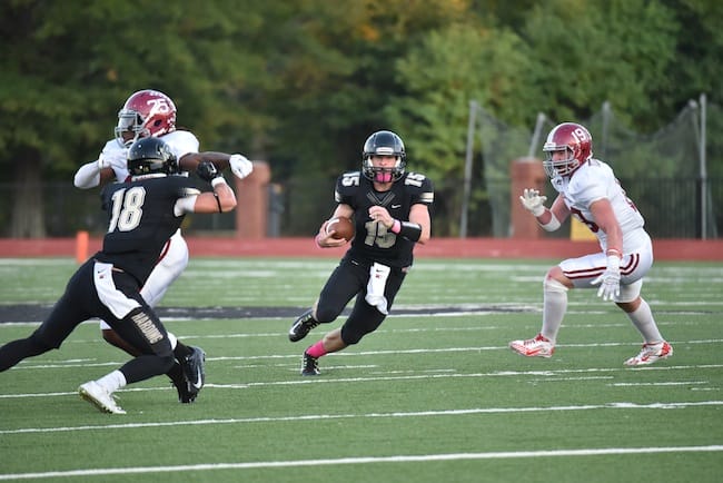 3 Harding Bisons quarterback Park Parish runs with football