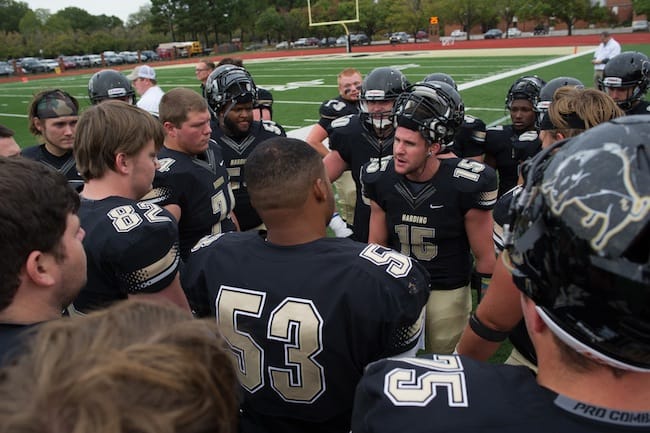 4 Harding Bisons huddle around quarterback Park Parish